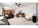 Spacious living room featuring leather sofas and a view into the kitchen at 5808 S Duquesne Ct, Aurora, CO 80016