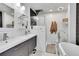 Bathroom featuring double sinks, a glass enclosed shower, and modern fixtures at 7918 S Depew St # D, Littleton, CO 80128