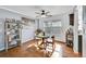 Bright dining room with hardwood floors, a ceiling fan, and stylish shelving for books and decorative items at 7918 S Depew St # D, Littleton, CO 80128