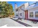 Charming home featuring light blue siding, red brick accents, and a neatly shoveled walkway in a snow-covered setting at 7918 S Depew St # D, Littleton, CO 80128