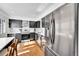 Modern kitchen featuring stainless steel appliances, black cabinets, and ample natural light from nearby windows at 7918 S Depew St # D, Littleton, CO 80128