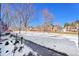 Exterior street view of townhomes and landscaped parkway, offering a glimpse of a charming neighborhood at 7918 S Depew St # D, Littleton, CO 80128