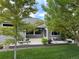 Landscaped backyard with deck, seating and lush green lawn at 8717 Forrest Dr, Highlands Ranch, CO 80126