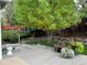 Lush backyard with seating on deck and beautiful flowering plant accents at 8717 Forrest Dr, Highlands Ranch, CO 80126