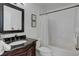 Bathroom with a black granite countertop vanity, and a shower with a white curtain at 8415 Pebble Creek Way # 102, Highlands Ranch, CO 80126