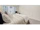 Bright bedroom featuring a large window, comfortable bed and a neutral color scheme at 8415 Pebble Creek Way # 102, Highlands Ranch, CO 80126