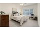 Bedroom with soft bed, a scenic painting, and a window, offering a tranquil retreat at 8415 Pebble Creek Way # 102, Highlands Ranch, CO 80126