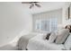 Bedroom featuring a soft bed with a ceiling fan and a window, creating a cozy and bright atmosphere at 8415 Pebble Creek Way # 102, Highlands Ranch, CO 80126