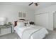 Bedroom with bed, ceiling fan, and decorative tables, creating a serene retreat at 8415 Pebble Creek Way # 102, Highlands Ranch, CO 80126