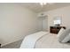 A bright bedroom space featuring neutral carpeting and a view into the hall at 8415 Pebble Creek Way # 102, Highlands Ranch, CO 80126