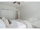 Bedroom with soft bed, ceiling fan, and double closet, offering comfort and functionality at 8415 Pebble Creek Way # 102, Highlands Ranch, CO 80126