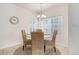 Inviting dining area featuring a round table, wicker chairs and large windows at 8415 Pebble Creek Way # 102, Highlands Ranch, CO 80126