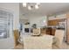 Open-concept dining and living area with modern lighting and seamless transition to the kitchen at 8415 Pebble Creek Way # 102, Highlands Ranch, CO 80126