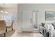 Bright entryway with a white front door, tile flooring, and access to the dining area at 8415 Pebble Creek Way # 102, Highlands Ranch, CO 80126