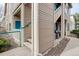 View of the condo's exterior with access to the balcony, a small patio, and landscaping at 8415 Pebble Creek Way # 102, Highlands Ranch, CO 80126