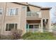 Image of the condo showing the two-story design, balconies, and landscaping around the building at 8415 Pebble Creek Way # 102, Highlands Ranch, CO 80126
