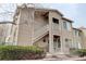 Exterior of the condo building featuring two floors, private balconies, and attractive landscaping at 8415 Pebble Creek Way # 102, Highlands Ranch, CO 80126