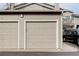 A two car garage featuring neutral garage doors at 8415 Pebble Creek Way # 102, Highlands Ranch, CO 80126