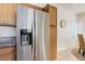 Stainless steel refrigerator and wood cabinets, offering storage and style at 8415 Pebble Creek Way # 102, Highlands Ranch, CO 80126