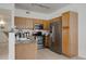 Well-equipped kitchen with stainless steel appliances and wood cabinets at 8415 Pebble Creek Way # 102, Highlands Ranch, CO 80126