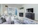 Bright living room with a fireplace, sliding glass doors to the balcony, and stylish decor at 8415 Pebble Creek Way # 102, Highlands Ranch, CO 80126