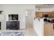 Bright and airy living space with a view of the kitchen, offering an open floor plan at 8415 Pebble Creek Way # 102, Highlands Ranch, CO 80126