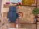 This aerial view shows the large backyard with raised garden beds and detached garage at 889 Douglas Dr, Denver, CO 80221