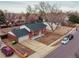Aerial view showcasing the home's brick exterior, detached garage, and convenient street parking at 889 Douglas Dr, Denver, CO 80221