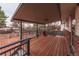 Enjoy outdoor dining on this back deck with overhead coverage and wrought iron railing at 889 Douglas Dr, Denver, CO 80221