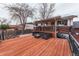 Outdoor seating is available on this back deck which is accessed via steps from the backyard at 889 Douglas Dr, Denver, CO 80221
