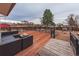 Spacious back deck with outdoor seating, ideal for enjoying the backyard view at 889 Douglas Dr, Denver, CO 80221