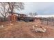 Large backyard with garden beds, fire pit, a two-level deck and mature trees at 889 Douglas Dr, Denver, CO 80221