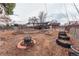 Large backyard featuring a fire pit, garden area and mature landscaping at 889 Douglas Dr, Denver, CO 80221