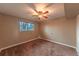 Bedroom features a ceiling fan, window, and neutral carpet at 889 Douglas Dr, Denver, CO 80221