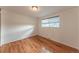 Cozy bedroom featuring hardwood floors, a neutral color scheme, and a window with natural light at 889 Douglas Dr, Denver, CO 80221