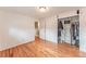Bedroom showcases hardwood floors, a closet with shelving, and an entrance to another room at 889 Douglas Dr, Denver, CO 80221