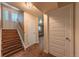 Inviting foyer with wooden staircase and decorative glass door welcomes you into this charming home at 889 Douglas Dr, Denver, CO 80221
