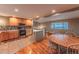 Modern kitchen with stainless steel appliances seamlessly connected to the dining area and living spaces at 889 Douglas Dr, Denver, CO 80221