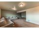 Spacious finished basement with a neutral-colored sectional at 889 Douglas Dr, Denver, CO 80221