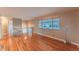 Bright and open living room with hardwood floors and a large window offering plenty of natural light at 889 Douglas Dr, Denver, CO 80221
