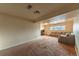 Open basement area with a large sectional sofa and natural light from a window at 889 Douglas Dr, Denver, CO 80221