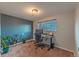 Bright office featuring a sleek adjustable desk, ergonomic chair, and ample natural light from the window at 889 Douglas Dr, Denver, CO 80221