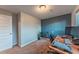 Office area with blue accent wall, plants, and modern desk at 889 Douglas Dr, Denver, CO 80221