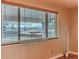 A room with a large window view with blinds showing the mountain landscape at 889 Douglas Dr, Denver, CO 80221