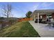 Fenced backyard includes a covered patio, seating area, and a well-maintained lawn at 4713 S Robb St, Littleton, CO 80127