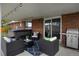 Back patio features seating area, a grill, and a hot tub, perfect for outdoor relaxation at 4713 S Robb St, Littleton, CO 80127