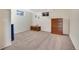 Basement area featuring carpet, egress windows, a dresser, and natural light at 4713 S Robb St, Littleton, CO 80127