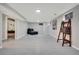 Spacious basement with neutral tile flooring, recessed lighting, and minimalist decor at 4713 S Robb St, Littleton, CO 80127