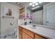 Bright bathroom with modern sink, decorative shelves, and artistic bear wall art at 4713 S Robb St, Littleton, CO 80127