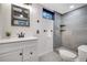 Modern bathroom featuring a tiled shower, a vessel sink, and elegant fixtures at 4713 S Robb St, Littleton, CO 80127